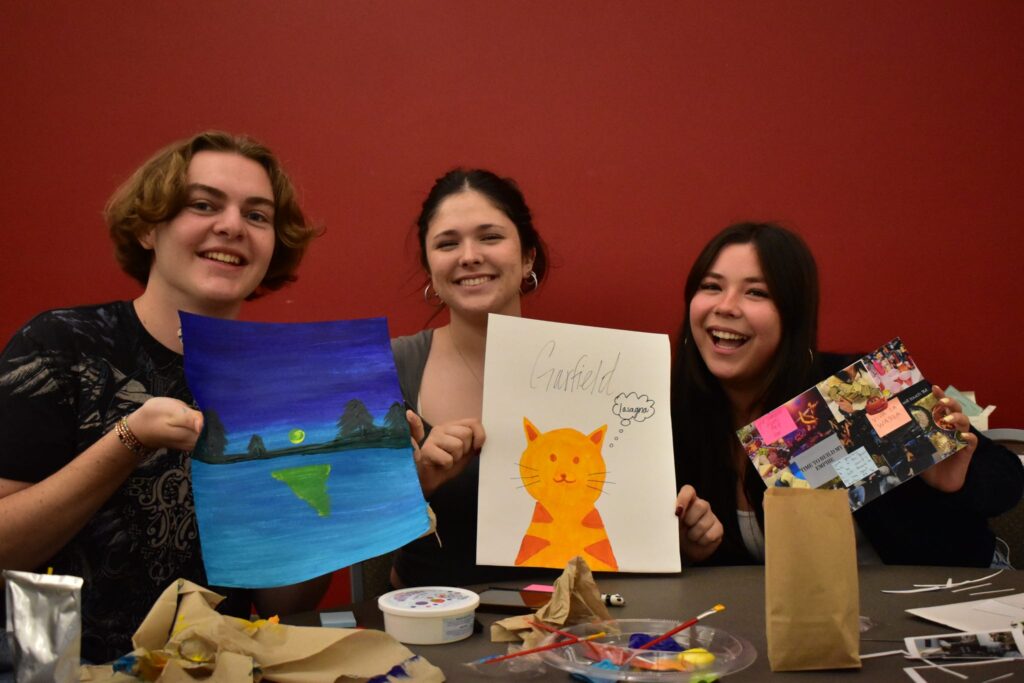 KAPi members holding up their artwork made at a mental health awareness workshop